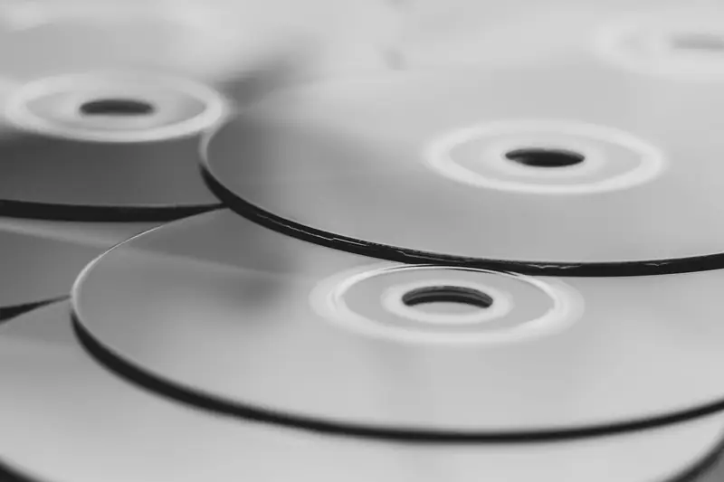 Monochrome close-up view of stacked optical discs. Minimalist design in grayscale