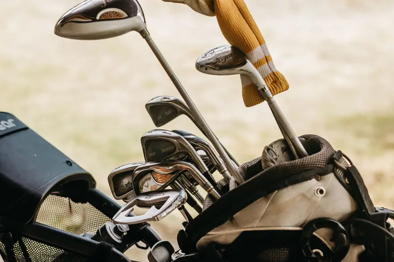 A detailed close-up of golf clubs in a bag, perfect for sports enthusiasts